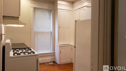 A kitchen with a stove and cabinets.