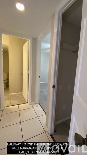 A hallway leading to the second bathroom and second bedroom.