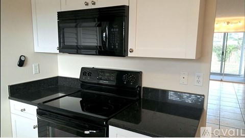 A black stove top oven and microwave in a kitchen.