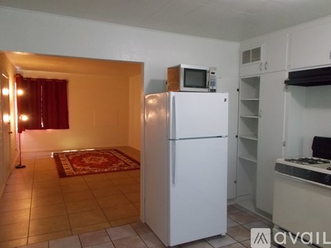A room with a ceiling fan and a door.