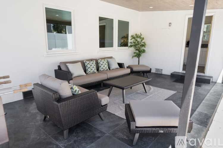 A living room with a couch, chair, and coffee table.