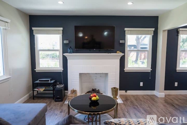 A living room with a fireplace and a television.