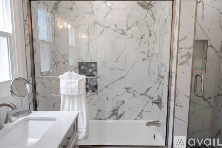 A bathroom with marble walls and a white sink.
