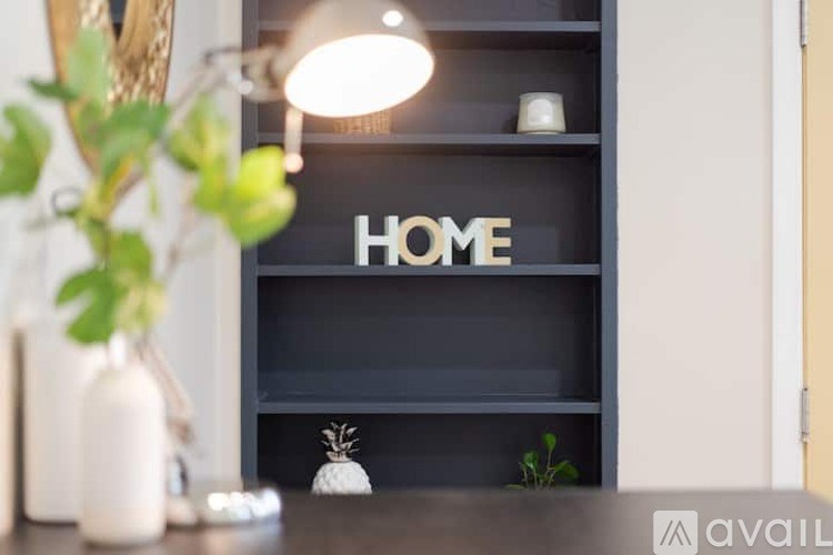 A shelf with the word HOME on it is in the background.