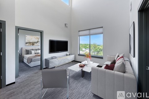 A modern living room with a grey sofa and a television.