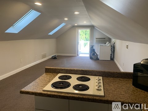 A kitchen with a granite countertop and a stove top oven.