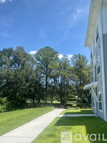 A white house with a walkway in front of it.