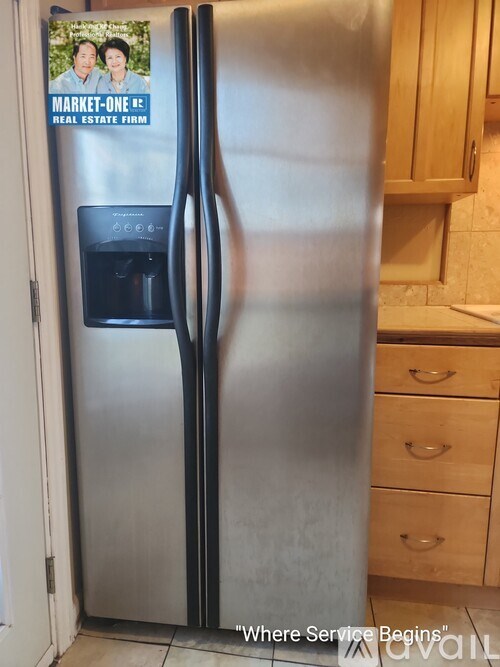 A bathroom with a tub, sink, and mirror.