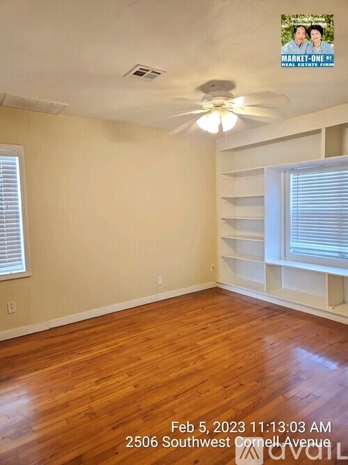 A room with wooden floors and a ceiling fan.