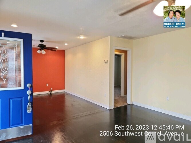 A room with a blue door and orange wall.