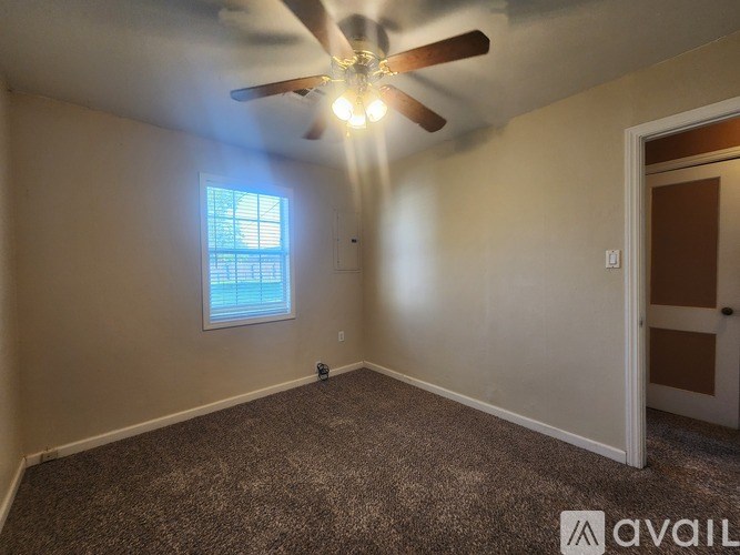 A small white house with a brown roof is located at 2506 Southwest Cornell Avenue.