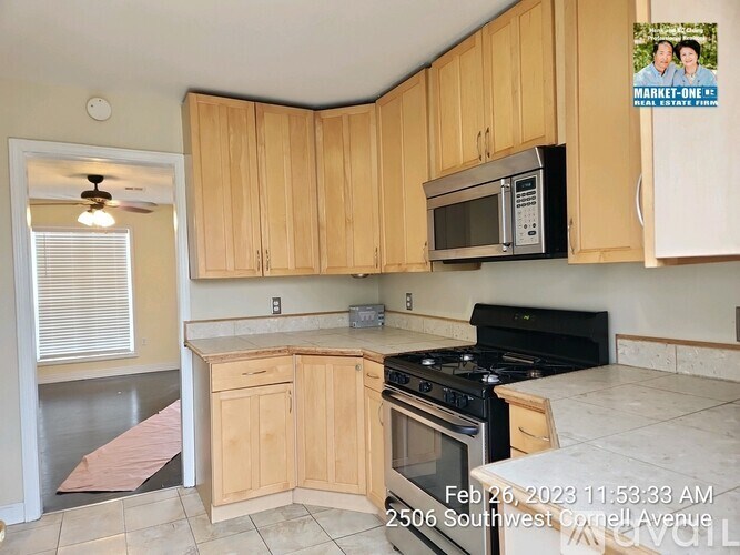 A kitchen with wooden cabinets and a black stove top oven.