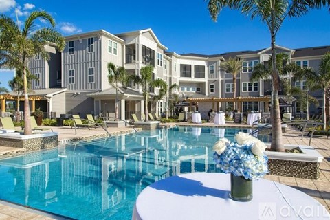 A large, modern building with a pool in front.