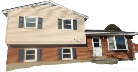 A two-story house with a beige upper floor and a red brick lower floor.