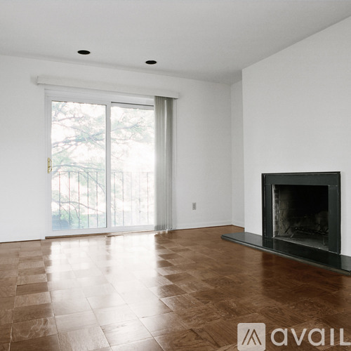 A living room with a fireplace and sliding glass doors.