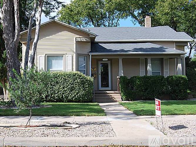 A house with a red and white sign in front.