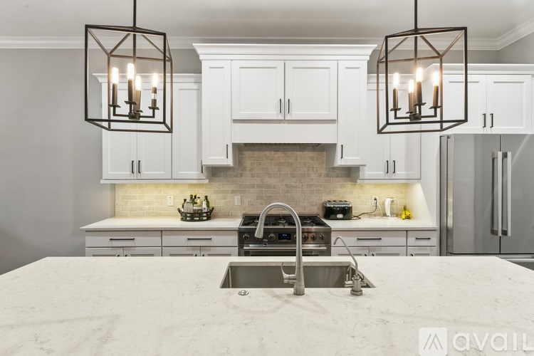 A kitchen with a stove top oven and a sink.