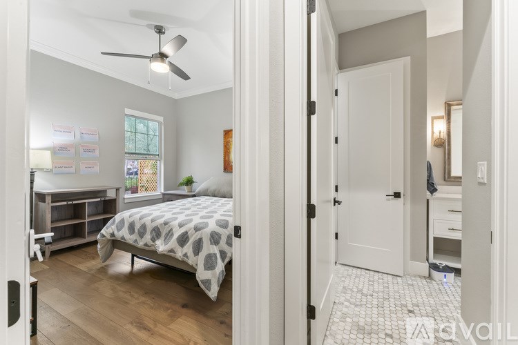 A bedroom with a bed, dresser, and mirror.