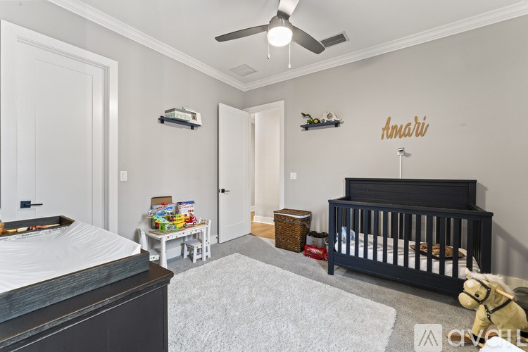 A baby room with a crib and a teddy bear.