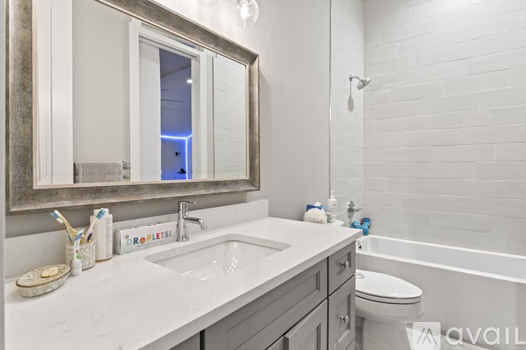 A bathroom with a white sink and a mirror above it.