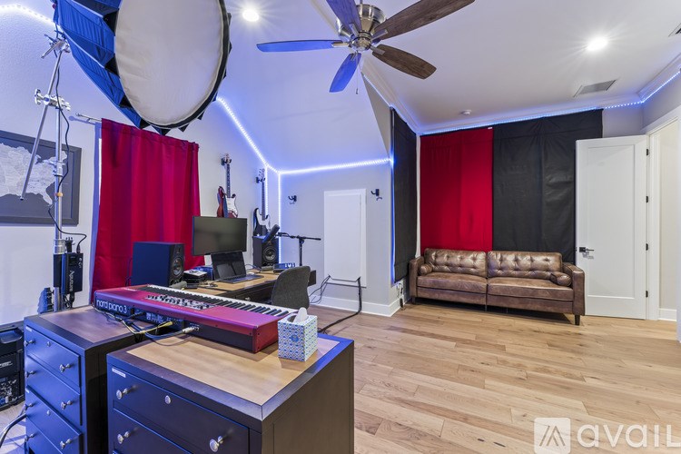 A room with a wooden desk and a couch.