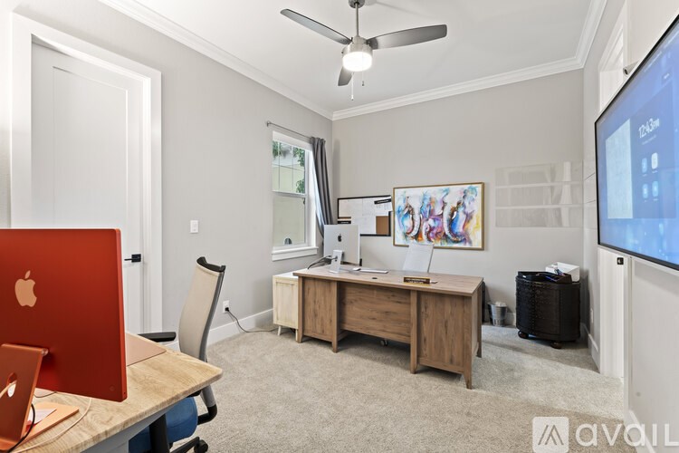 A room with a desk, chair, and computer.