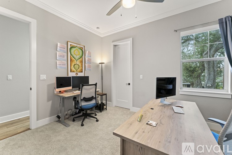 A room with a desk, chair, and computer setup.