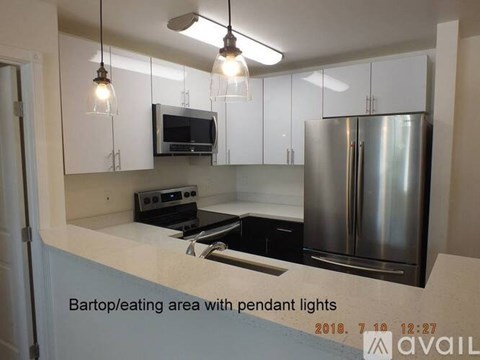 A kitchen with pendant lights above the counter.