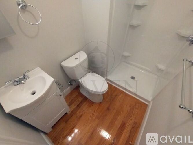A white toilet and sink in a small bathroom.