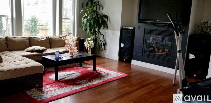 A living room with a couch, coffee table, and a fireplace.