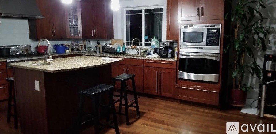 A kitchen with wooden cabinets and a granite countertop.
