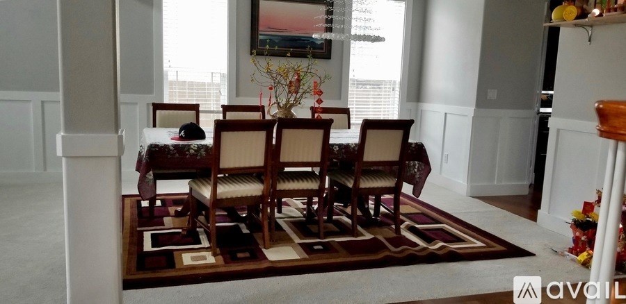 A dining room with a table and chairs.
