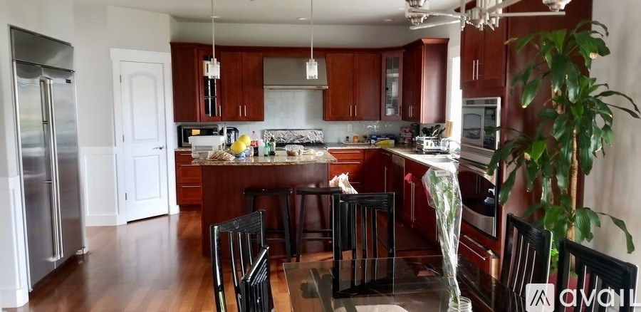 A kitchen with wooden cabinets and a refrigerator.