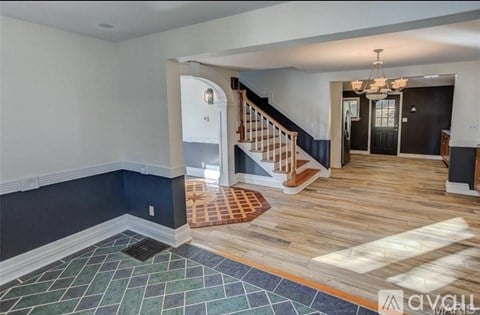 A living room with a staircase leading to the upper floor.