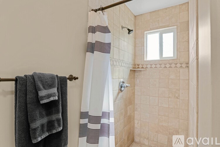 A bathroom with a towel hanging on a rack.
