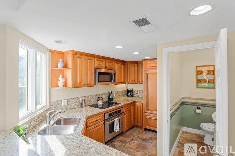 A kitchen with wooden cabinets and a sink.