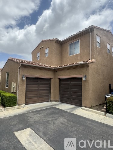 A house with a brown garage door is for sale.