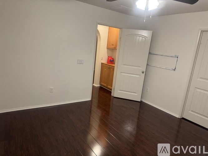 A room with a white door and a wooden cabinet.