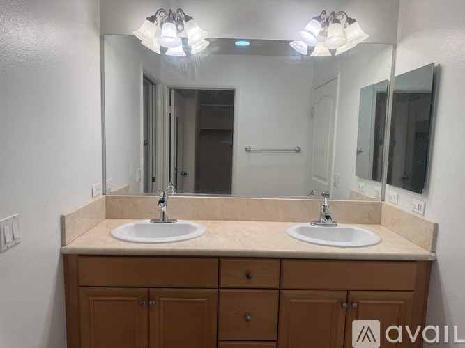 A bathroom with two sinks and a large mirror.
