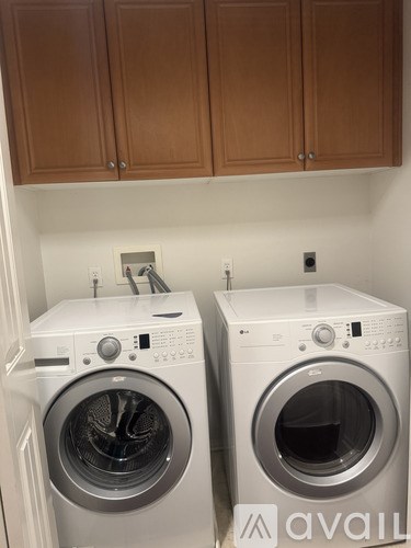 Two front load washing machines in a laundry room.
