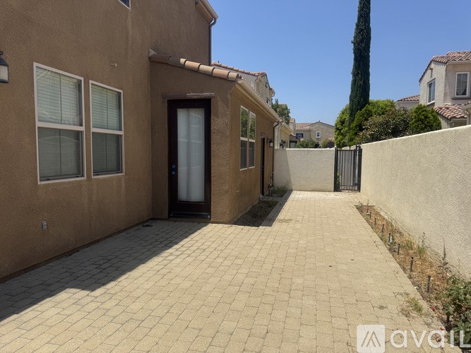A house with a brown wall and a black door.