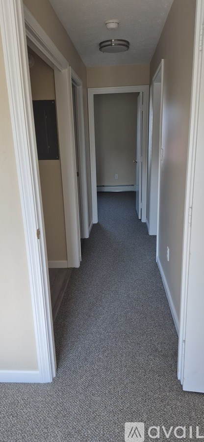A long hallway with doors on both sides.