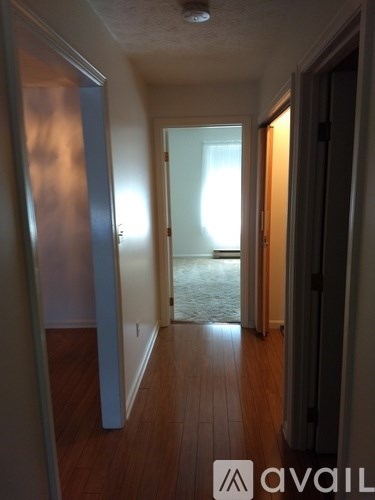 A hallway with a door at the end.
