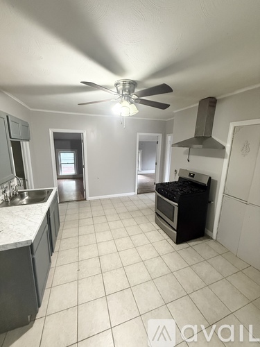 A kitchen with a table and chairs in the middle of the room.