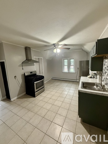 A kitchen with a table and chairs in the middle of the room.