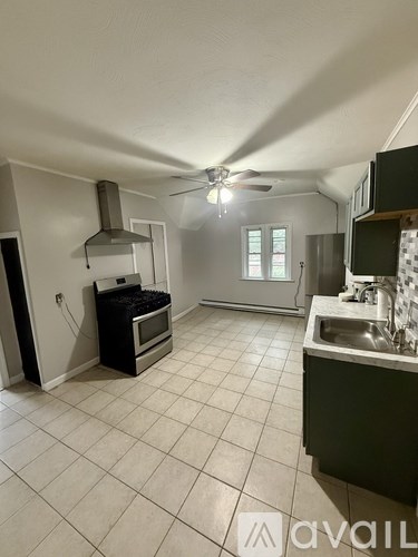 A kitchen with a table and chairs in the middle of the room.
