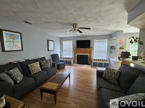 A living room with a grey couch and a wooden coffee table.