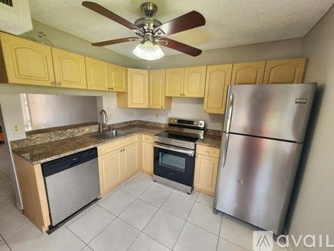 A kitchen with a stainless steel refrigerator, oven, and microwave.