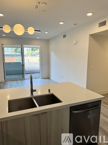 A kitchen with a sink and a window.