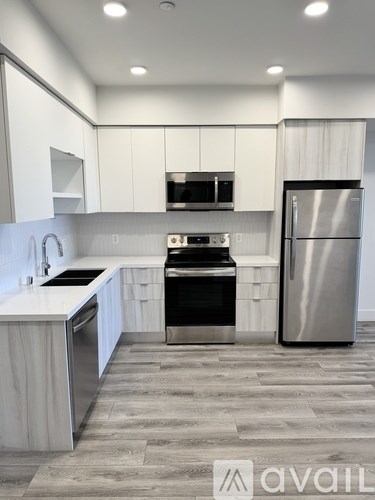 A modern kitchen with a refrigerator on the right.